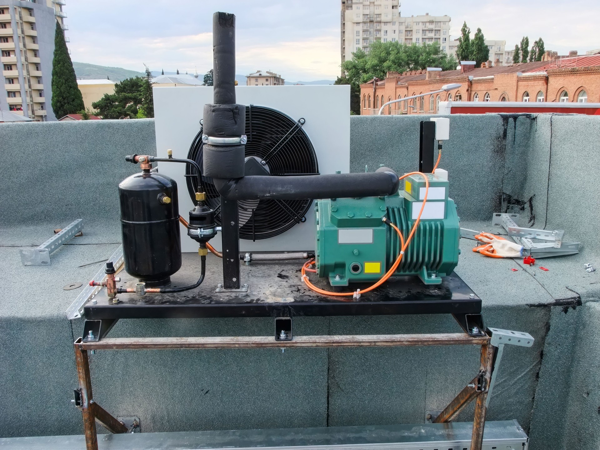 HVAC equipment installation on a restaurant rooftop, featuring a compressor and air conditioner.